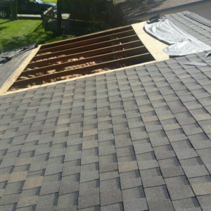 Roof installation in progress with new shingles and exposed rafters by Xavier Roofing & Remodeling in Dayton, OH.
