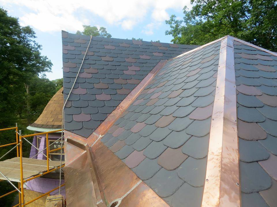 Roof renovation project showing slate and copper work with scaffolding by Copper & Slate Inc. in Buffalo, NY