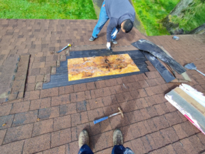 Two handymen performing roof repair and shingle replacement services for JJU Property Maintenance, LLC in Salem, OR.