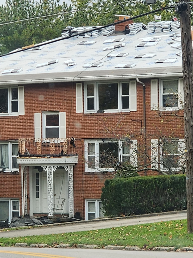 Roof replacement in progress on a brick building, showcasing handyman services by RD Construction LLC in Youngstown, OH.
