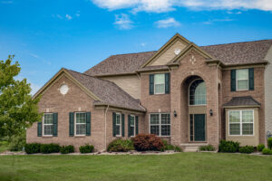 An aerial view of a house with a roof replacement in progress by Sherriff-Goslin Roofing Contractors in Flint, MI