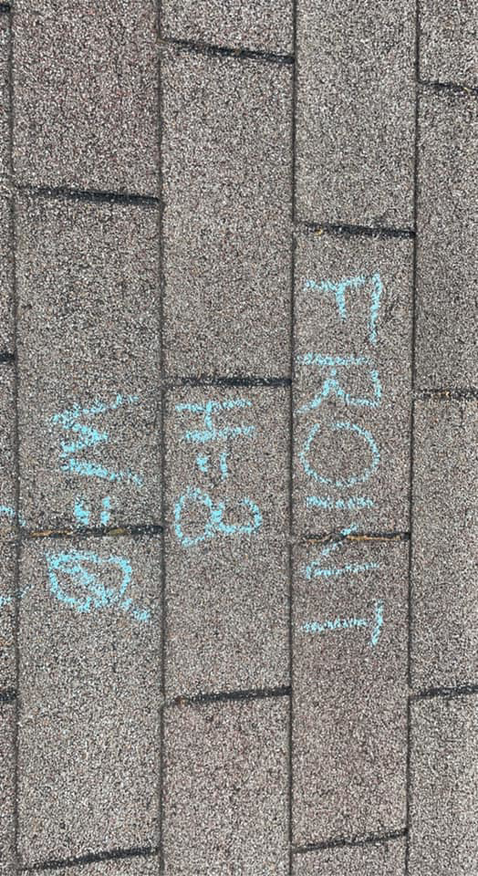 A shingle roof with blue chalk writing "FRONT" and "BACK" to mark sections for repair or replacement by Ramirez Roofing and Repair, LLC in Kansas City, MO.