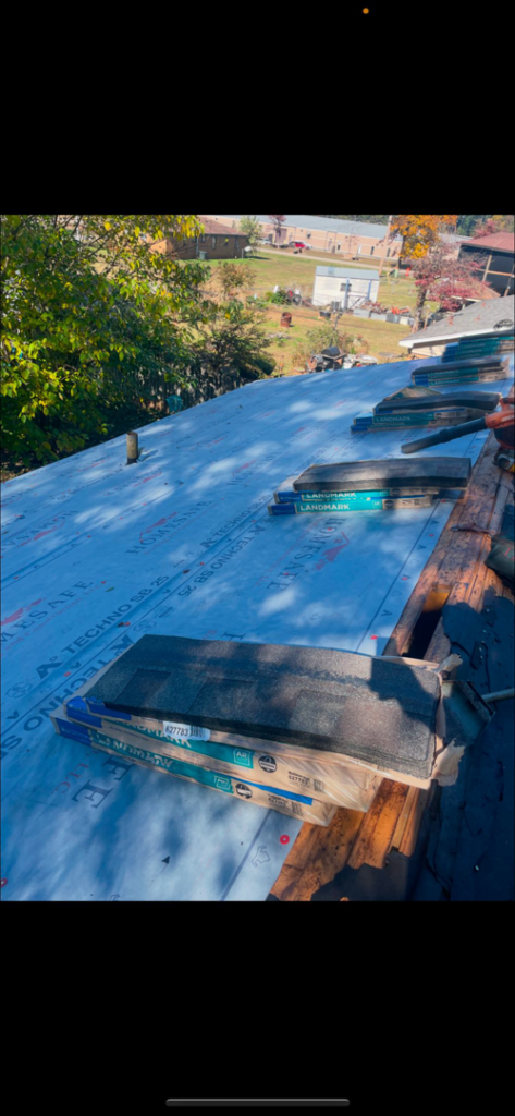 Roofing work in progress, showing underlayment and bundles of new shingles on a roof by AK Overhead Door & Handyman Services in Wetumpka, AL.