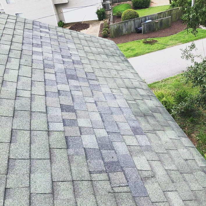 A section of roof shingles being repaired or replaced by Blue Mountain Home & Chimney in Virginia Beach, VA.