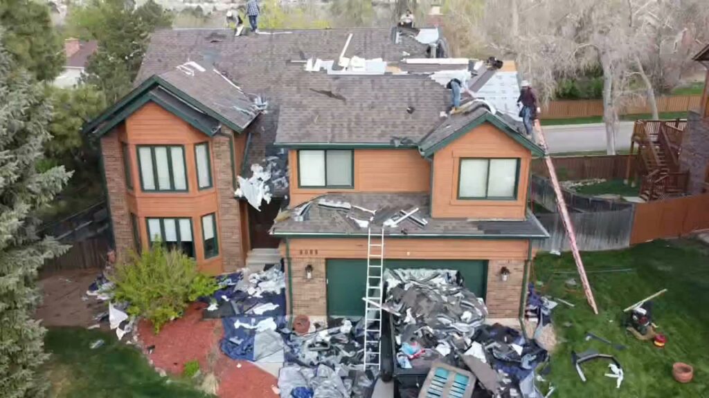 An aerial view of a house during roof tear-off and replacement, handled by Jesse Roofs Co. in Denver, CO
