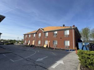 Roof tear-off and underlayment installation on a commercial building by Elegant Home Exteriors in Flourance, KY.