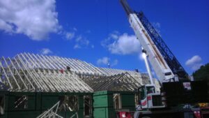 Roof trusses being installed on a large construction site by Mendez Contractor Inc in Lynn, MA