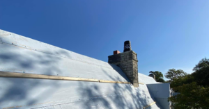 Roof underlayment and wooden battens installed around a chimney during a roofing project by J&J ultimate roofing llc in Austin, TX