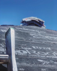 Roof underlayment being installed with a ladder, showcasing roofing services by Power Roofing & Construction in Norman, OK.