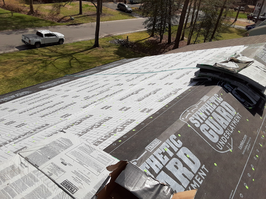Synthetic underlayment installed on a roof with bundles of shingles ready for installation by Knupp Konstruction in Salisbury, MD.