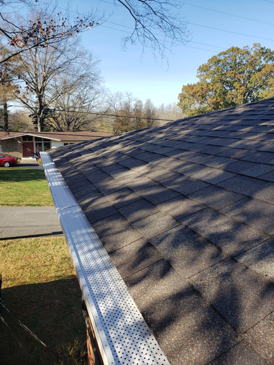 A residential roof with newly installed gutter guards by A1 Roofing in Scottsdale, AZ