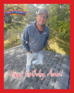 A roofer standing on a newly shingled roof, showcasing quality work by All American Roofing and Restoration in Rogers, MN.