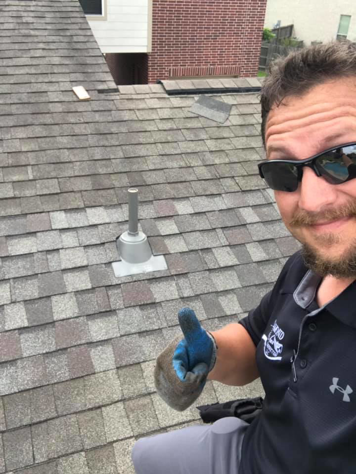A roofer giving a thumbs up on a shingle roof, showcasing work by Rob the Roofer in Houston, TX.