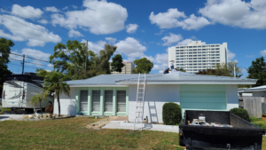 Roofers installing a new metal roof on a residential home, managed by Florida Roof & Building Services LLC in Ellenton, FL.