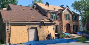 Professional roofers installing new shingles on a residential home, a service provided by RepairTo Roofing, Renovations & Repairs in Wilmington, DE.