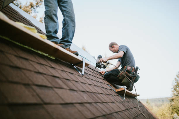Two professional roofers installing new shingles on a residential roof for Chris Roofing & Remodeling Inc. in Colorado Springs, CO