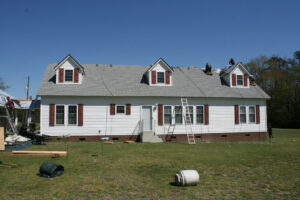 A roofing crew installing new shingles on a residential home, a handyman service by Consolidated Roofing Systems, Inc. in Cary, NC