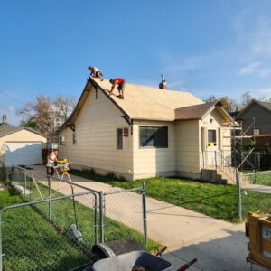 Roofing crew installing new shingles on a house by RC Contracting in Chesterfield, MO.