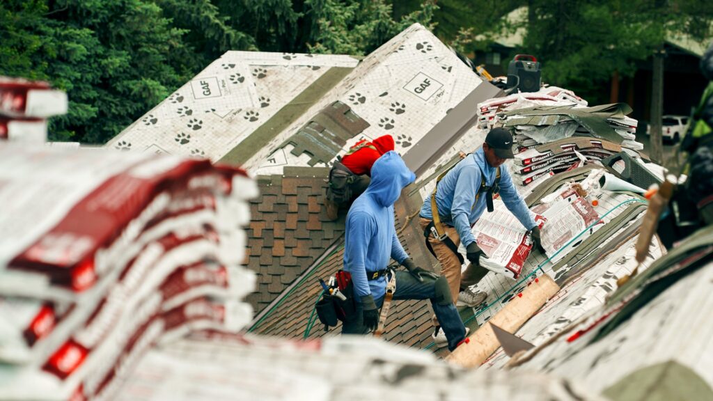 A roofing crew installing new shingles on a residential roof for Proline Roofing in Shipshewana, IN.