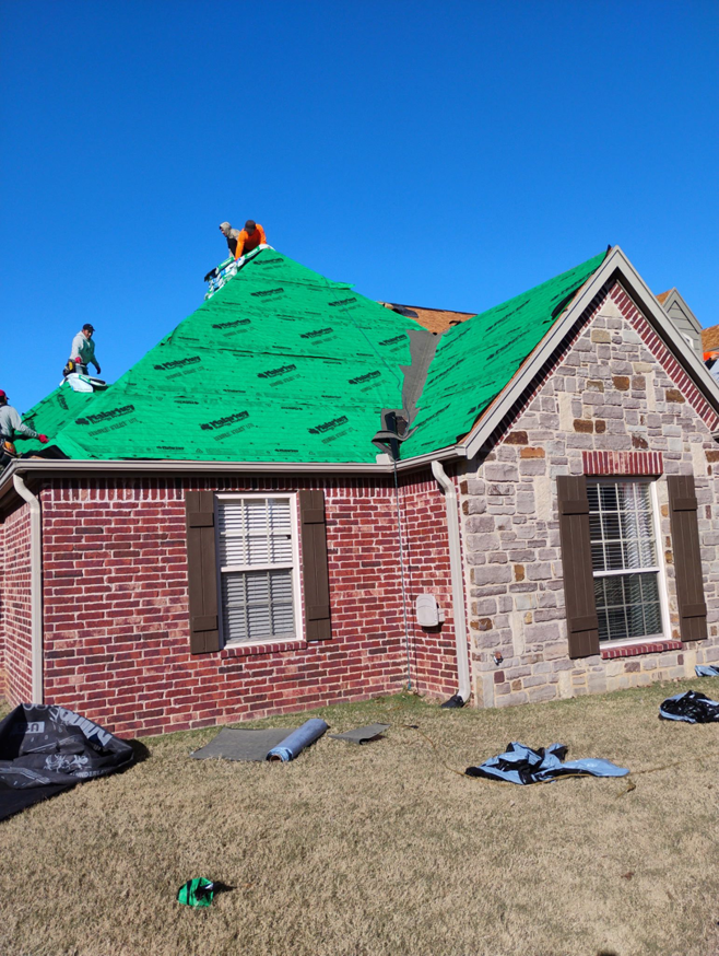 A roofing crew installing new shingles over green underlayment for Right Choice Roofing Oklahoma in Collinsville, OK.