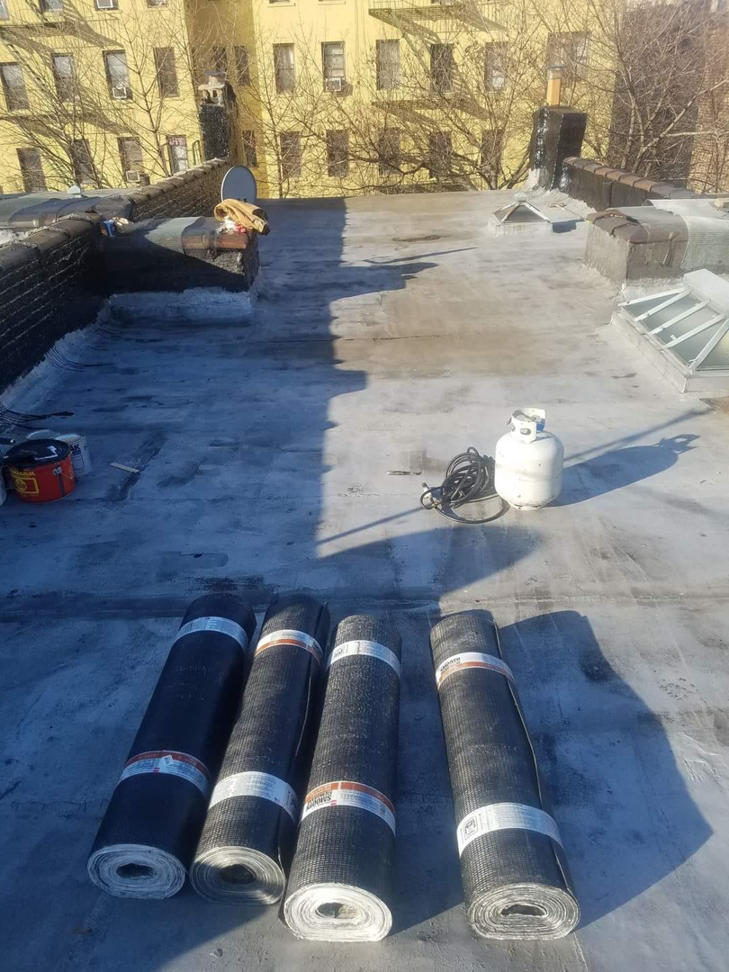 Rolls of roofing materials on a commercial flat roof project by The Best Larry Roofing corp in Mechanicsburg, PA