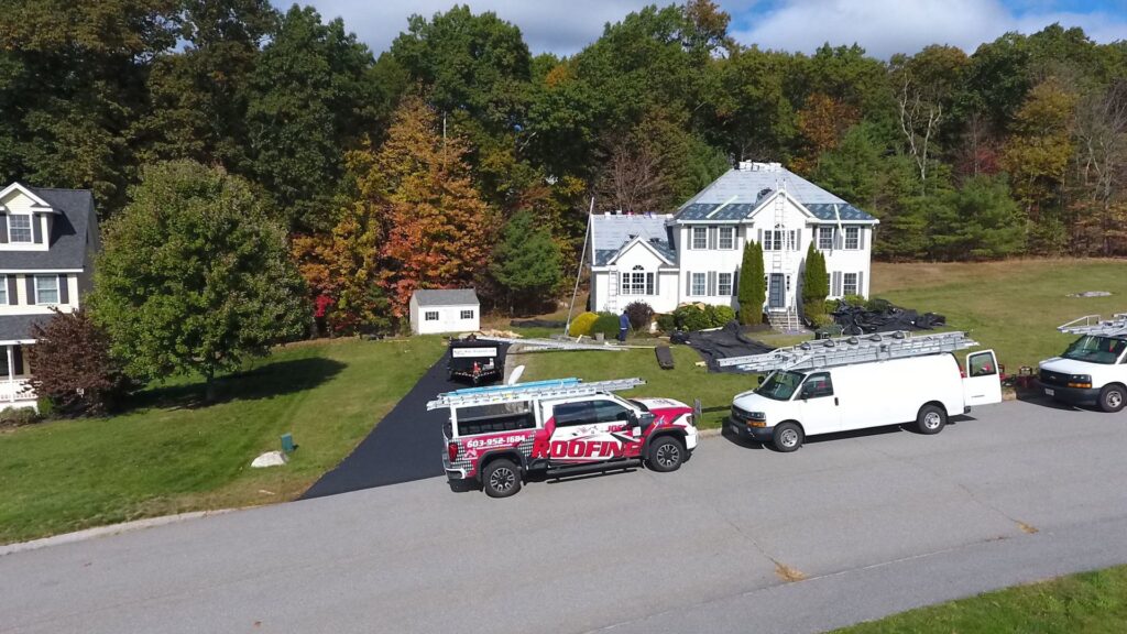 A roofing project site with Joe's Roofing work vehicles and a dumpster at a residential home in Strongsville, OH.