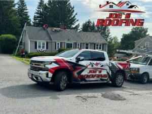 A Joe's Roofing branded truck parked outside a home where workers are performing a roofing project in Strongsville, OH.