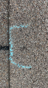 An asphalt shingle roof with a blue chalk mark, part of a repair assessment by Ramirez Roofing and Repair, LLC in Kansas City, MO.