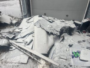 A pile of roofing shingles and construction debris covered in snow, requiring removal by Feelin Good Junk Removal & Estate Sales at 1111 Debra Lane.