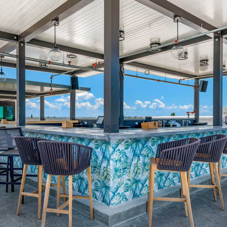 A stylish rooftop bar area, a completed commercial project by LEMA Construction, Inc. in Saint Petersburg, FL.