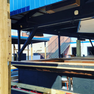 Rooftop bar under construction with exposed framing and plumbing, highlighting general contractor services from Tundo Construction & Design Corp in Buffalo, NY.