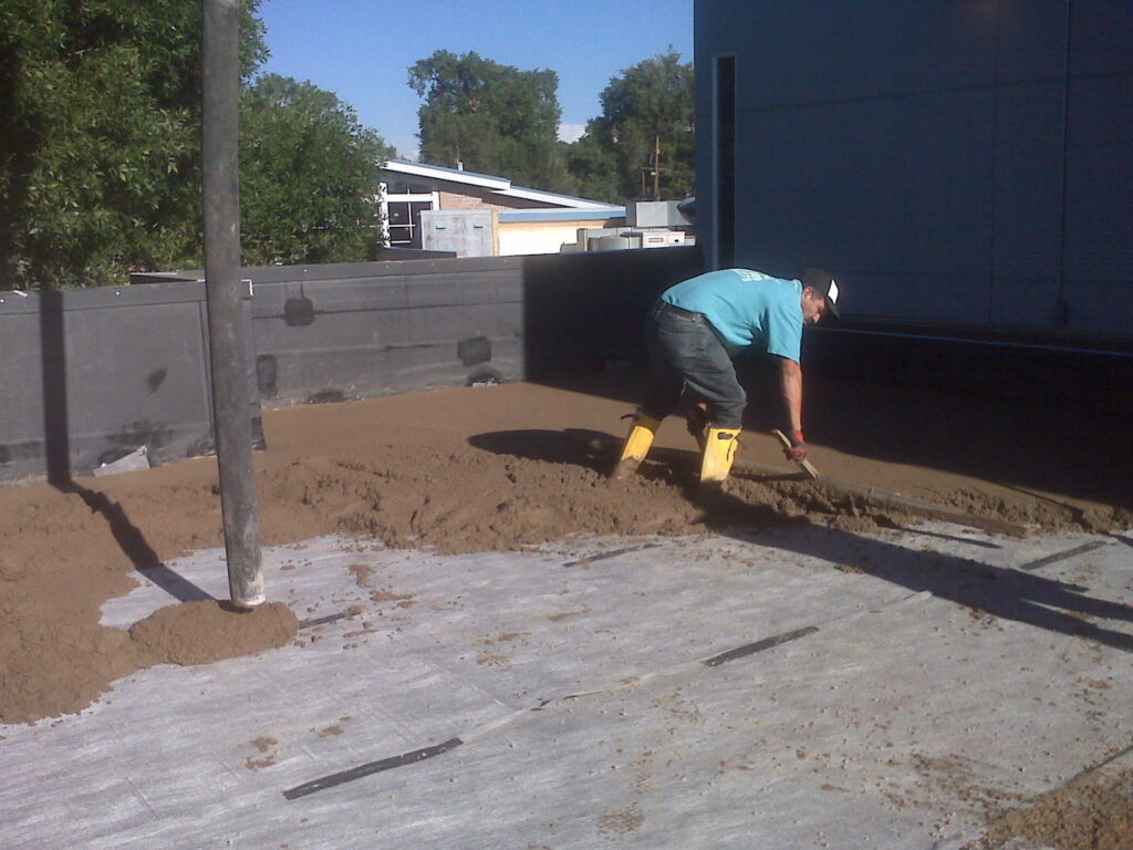 A worker performing rooftop repair or maintenance for Element Construction Company in Colorado Springs, CO.