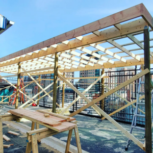 Wooden framing for a rooftop structure under construction, demonstrating general contractor expertise by Tundo Construction & Design Corp in Buffalo, NY.