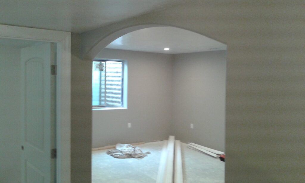A room featuring an arched doorway and new trim installation, a service provided by Eagle Rock Handyman Services in Caldwell, ID.
