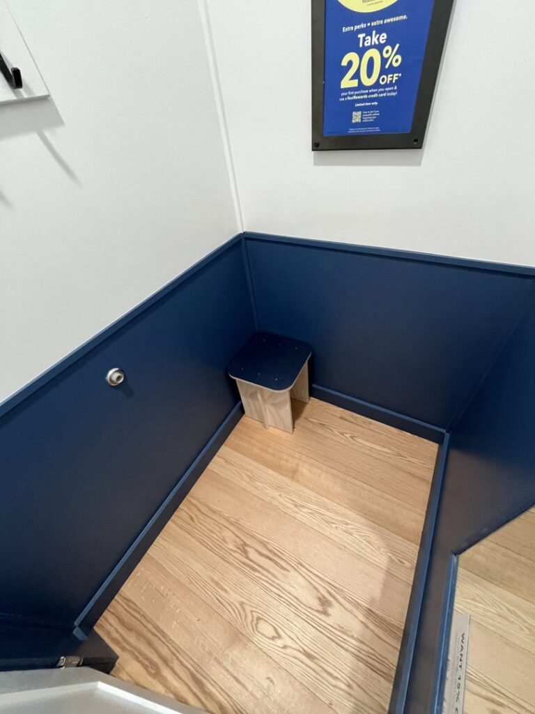 A room featuring blue wainscoting and a wooden floor, showcasing interior finishing by Dakota Small Jobs in Sioux Falls, SD.