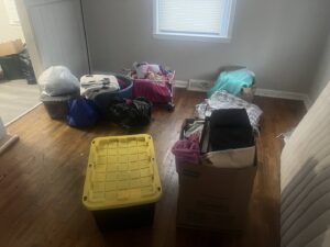 A room with several boxes and bags of items, indicating a cleanout or junk removal job for Feelin Good Junk Removal & Estate Sales at 1111 Debra Lane.