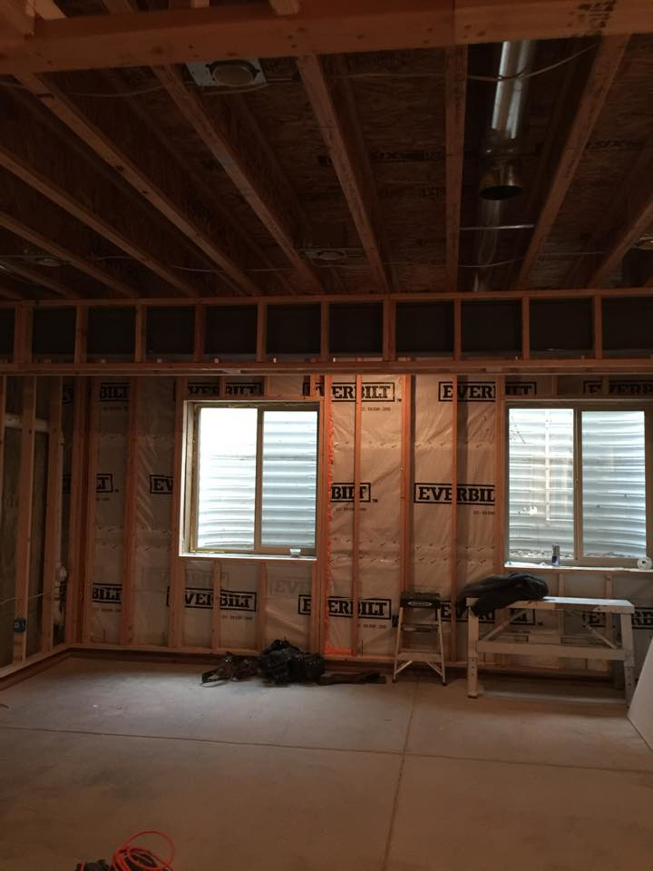 Room under construction with wall framing and insulation by Continental Drywall in Aurora, CO