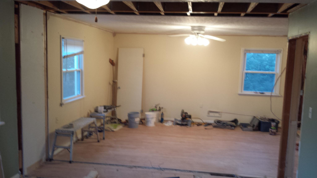 Room demolition and renovation preparation with exposed studs and tools, performed by Precision Painters in Louisville, KY