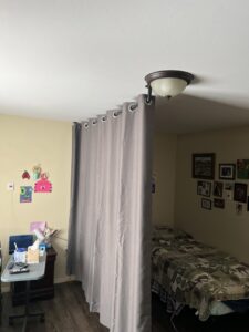 A ceiling-mounted curtain installed as a room divider by 1775 Handyman Services in Kalispell, MT.