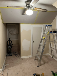 Room undergoing drywall ceiling repair with a ladder and tools, performed by Hewitt&Son in Newport News, VA.