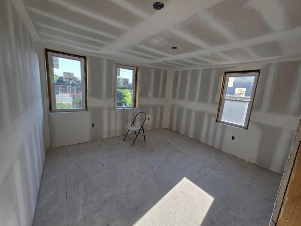 Room with new drywall installation and window framing by J M Construction & Remodeling in Humble, TX.