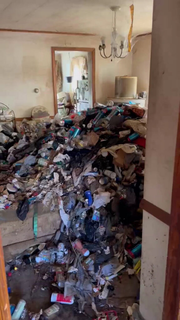 A room completely filled with trash, cans, and bottles, indicating an extreme junk removal or hoarding cleanup job by Junken Monkeys Hauling Company in Scranton, PA.