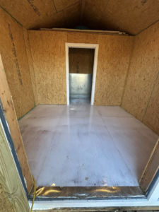 A room with OSB walls and a floor prepped for epoxy coating by Galaxy Epoxy in Madison, AL.