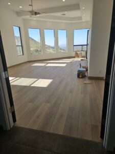 A newly renovated room with fresh flooring and large windows, completed by Integrity Contracting in Cleveland, OH