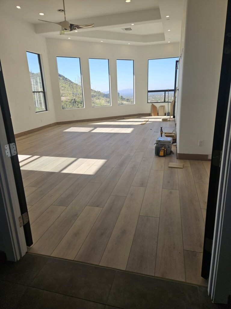 A newly renovated room with fresh flooring and large windows, completed by Integrity Contracting in Cleveland, OH