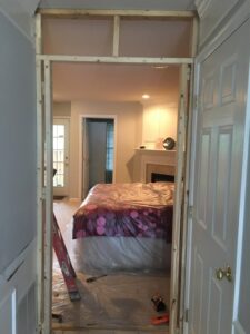 Room framing and renovation preparation with furniture covered by Quality Services, LLC in Alexandria, VA.