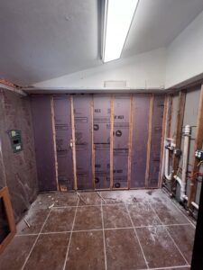 Room under construction with framing and insulation installation by Iron Horse Handyman Services LLC in Laramie, WY.