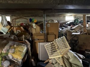 A room completely filled with clutter and junk, ready for a cleanout by Black Diamond Junk Removal in Bedford Heights, OH.