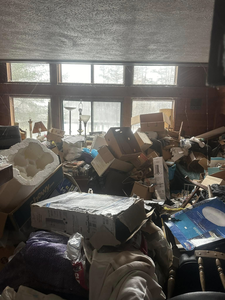 A room completely full of boxes and household items, awaiting general junk removal by White Dumpster in Alliance, OH.