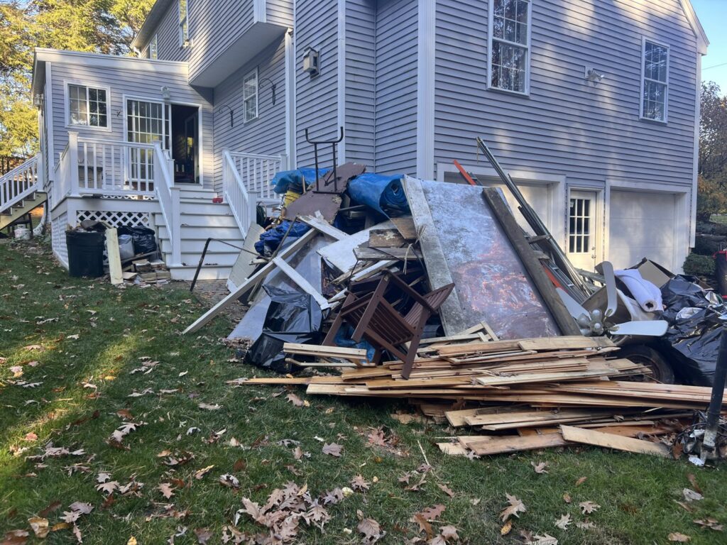 A room overflowing with cardboard boxes, insulation, and various debris, clearly showing a scene requiring junk removal by Trash King LLC in Peoria, AZ.